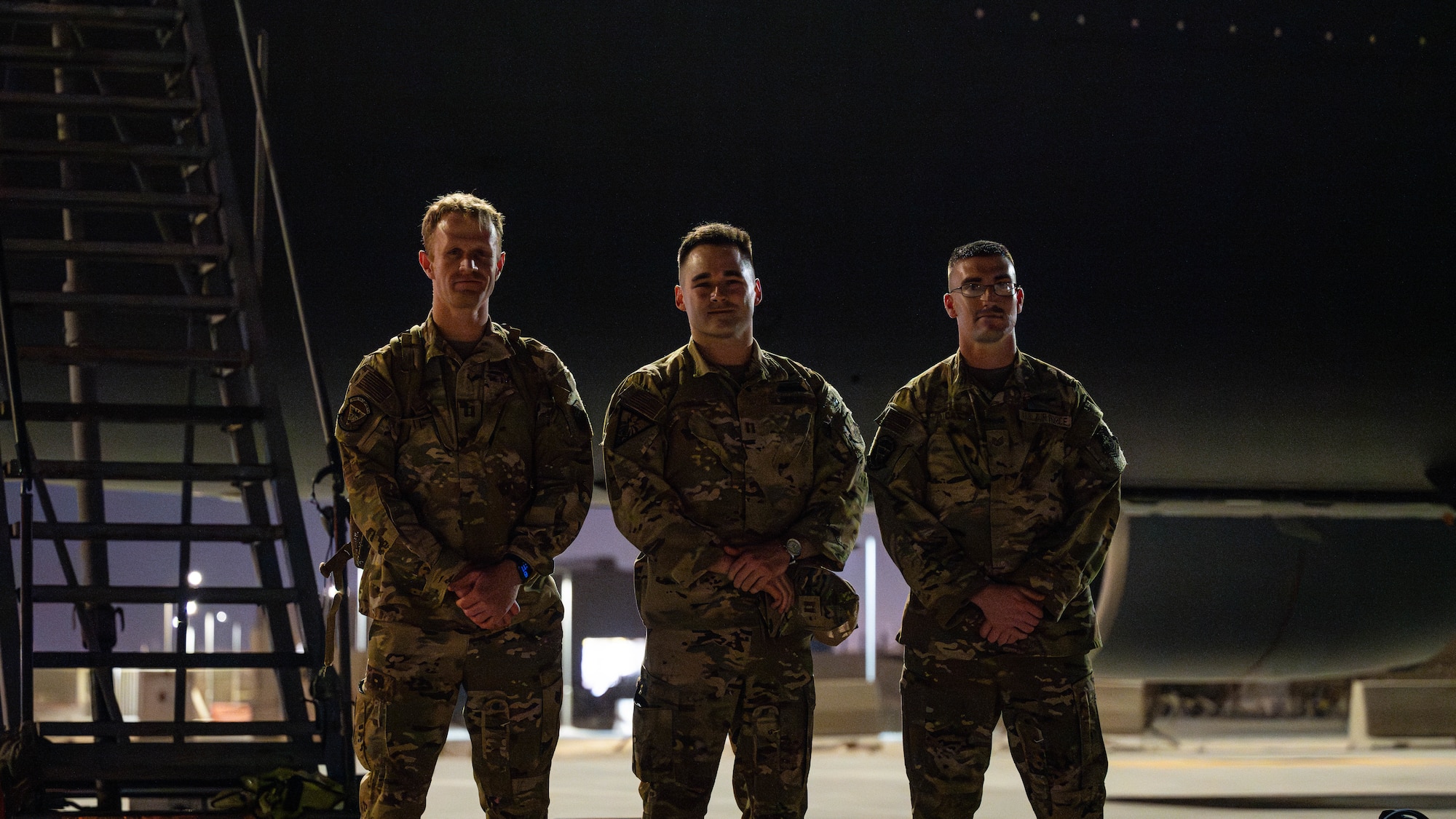 Three Airmen pose for photo.