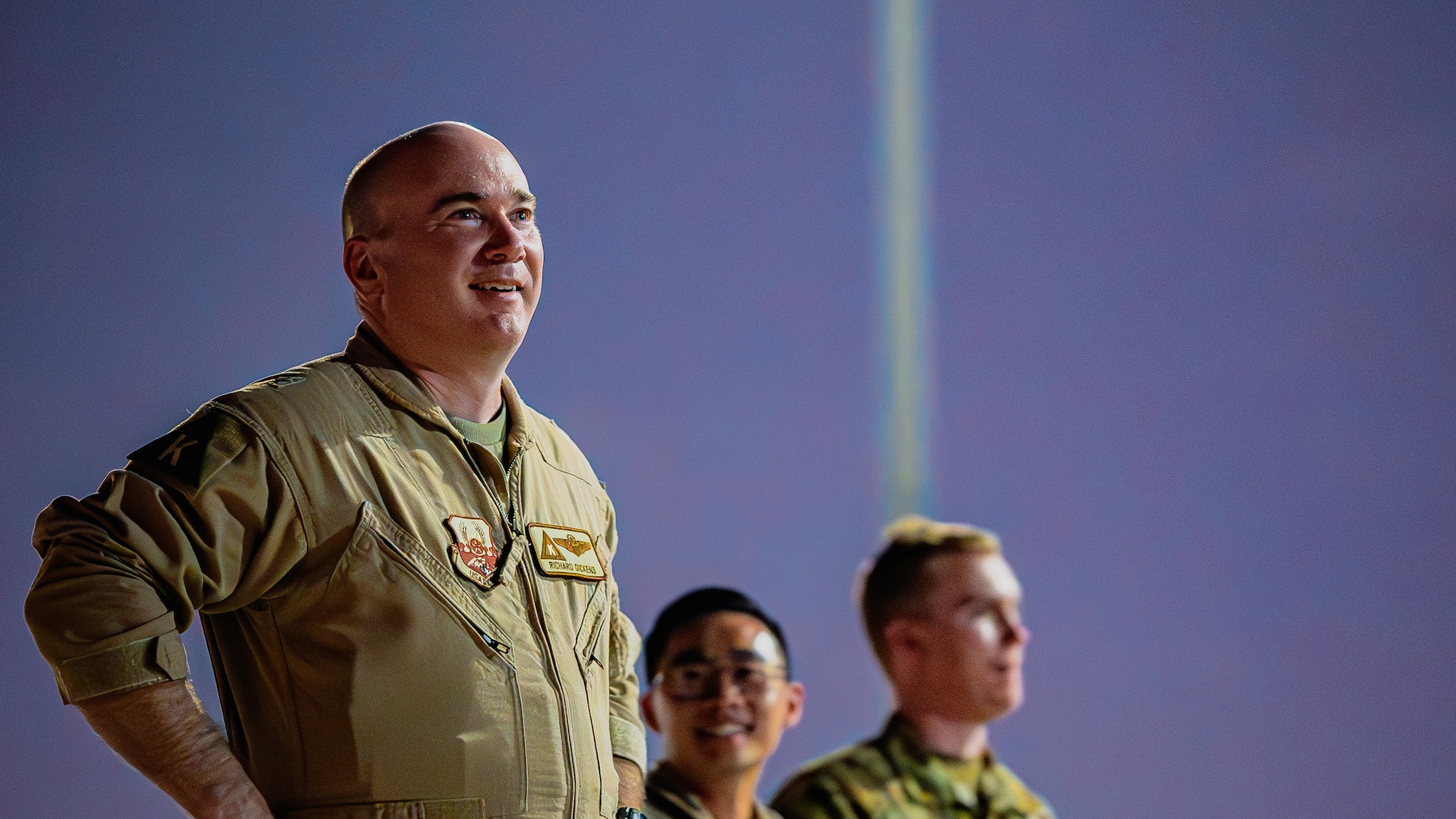 Airmen look into the distance.
