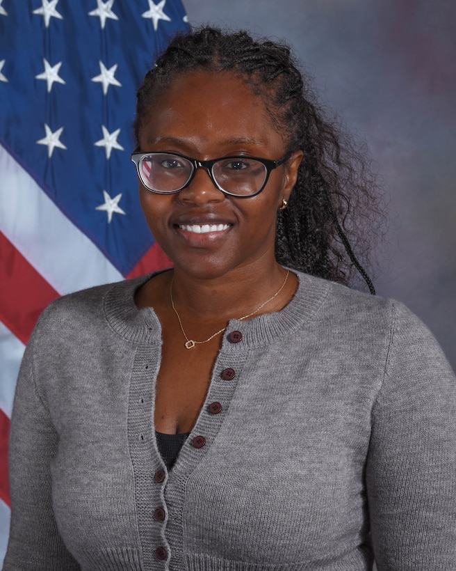 Photo of NDU employee in front of an American flag