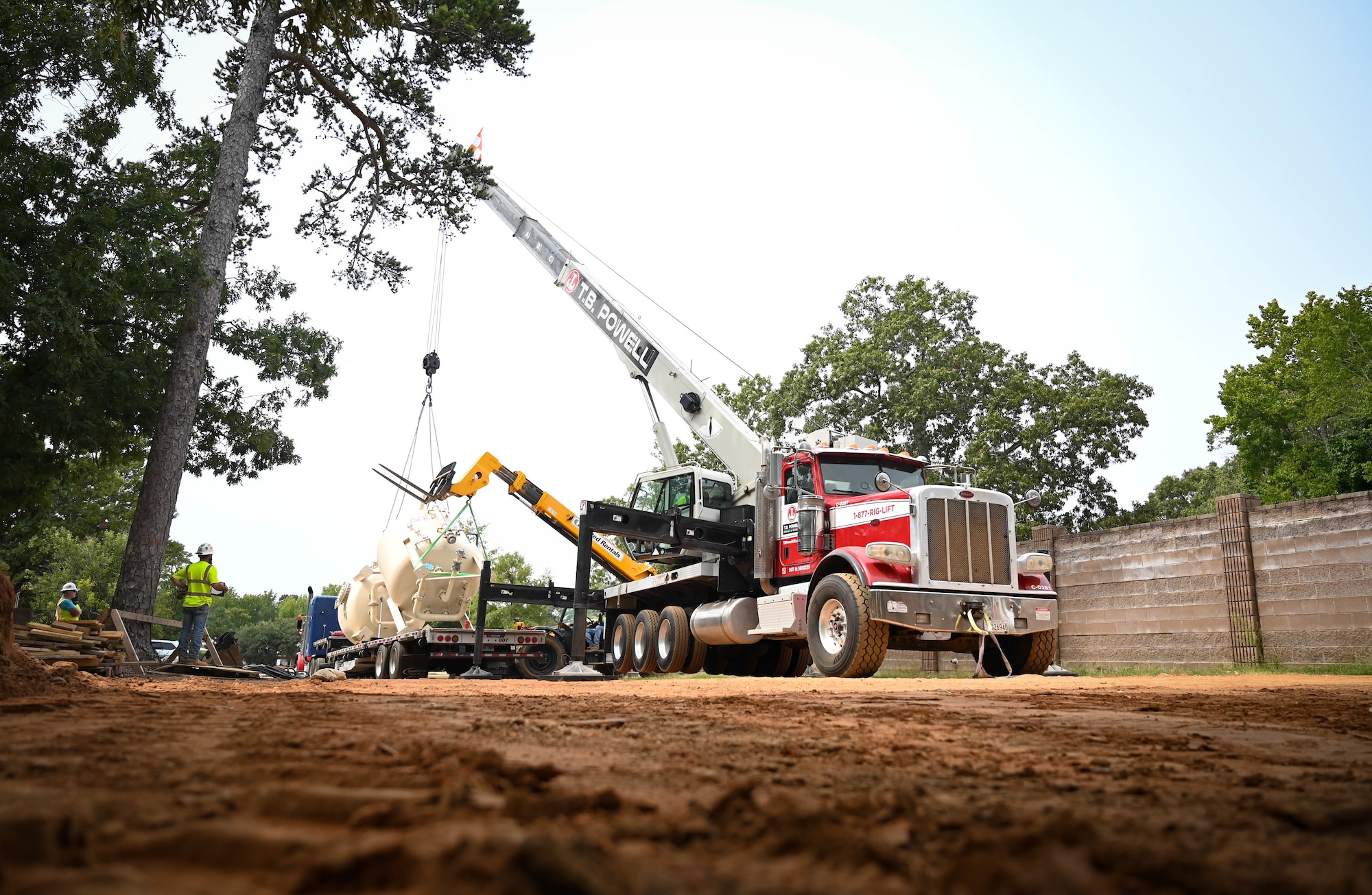 A crane prepares to lift a new water treatment device.