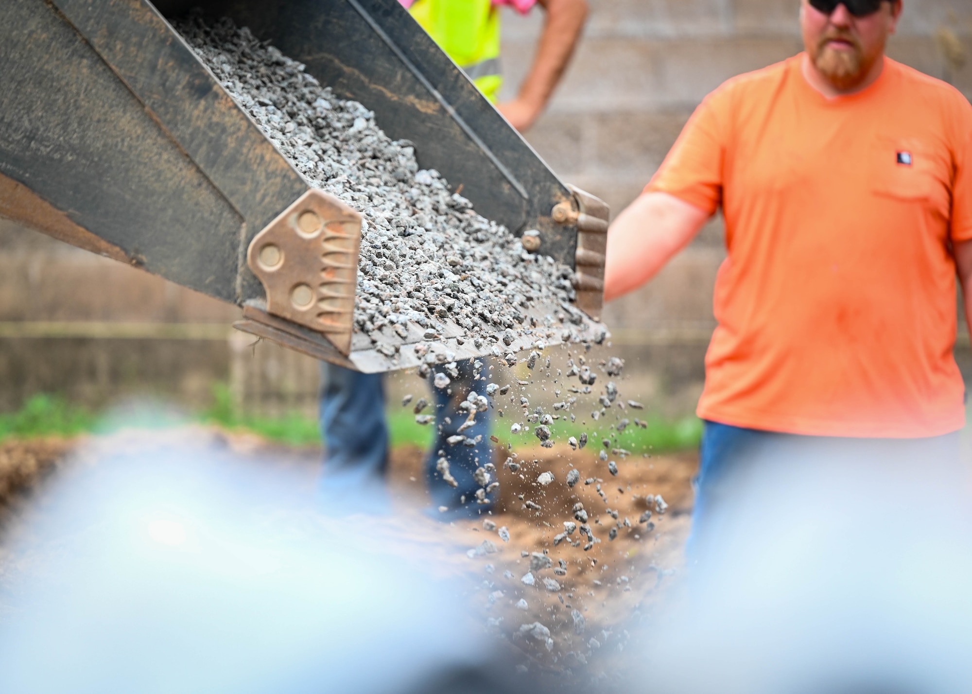 A machine drops soils back into a hole.
