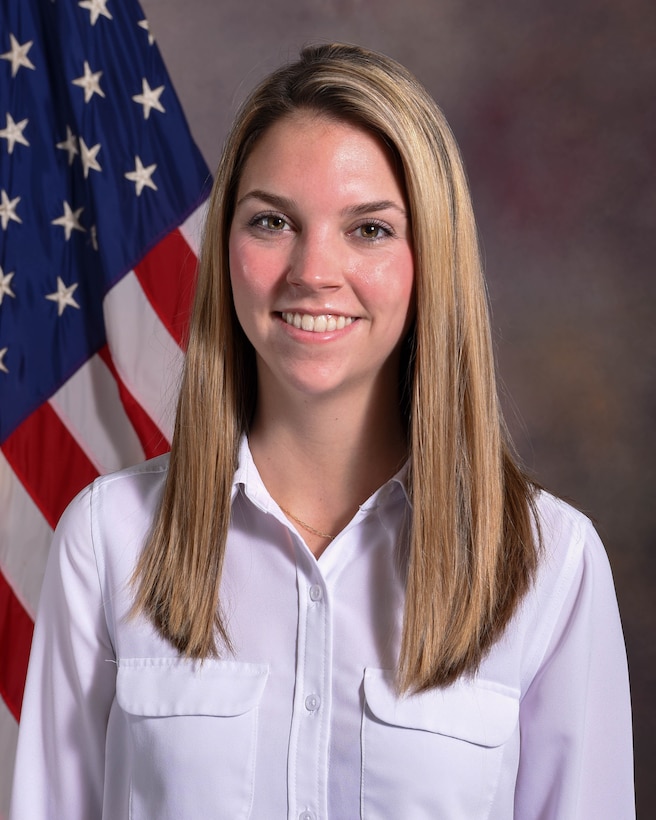 Photo of NDU employee in front of an American flag