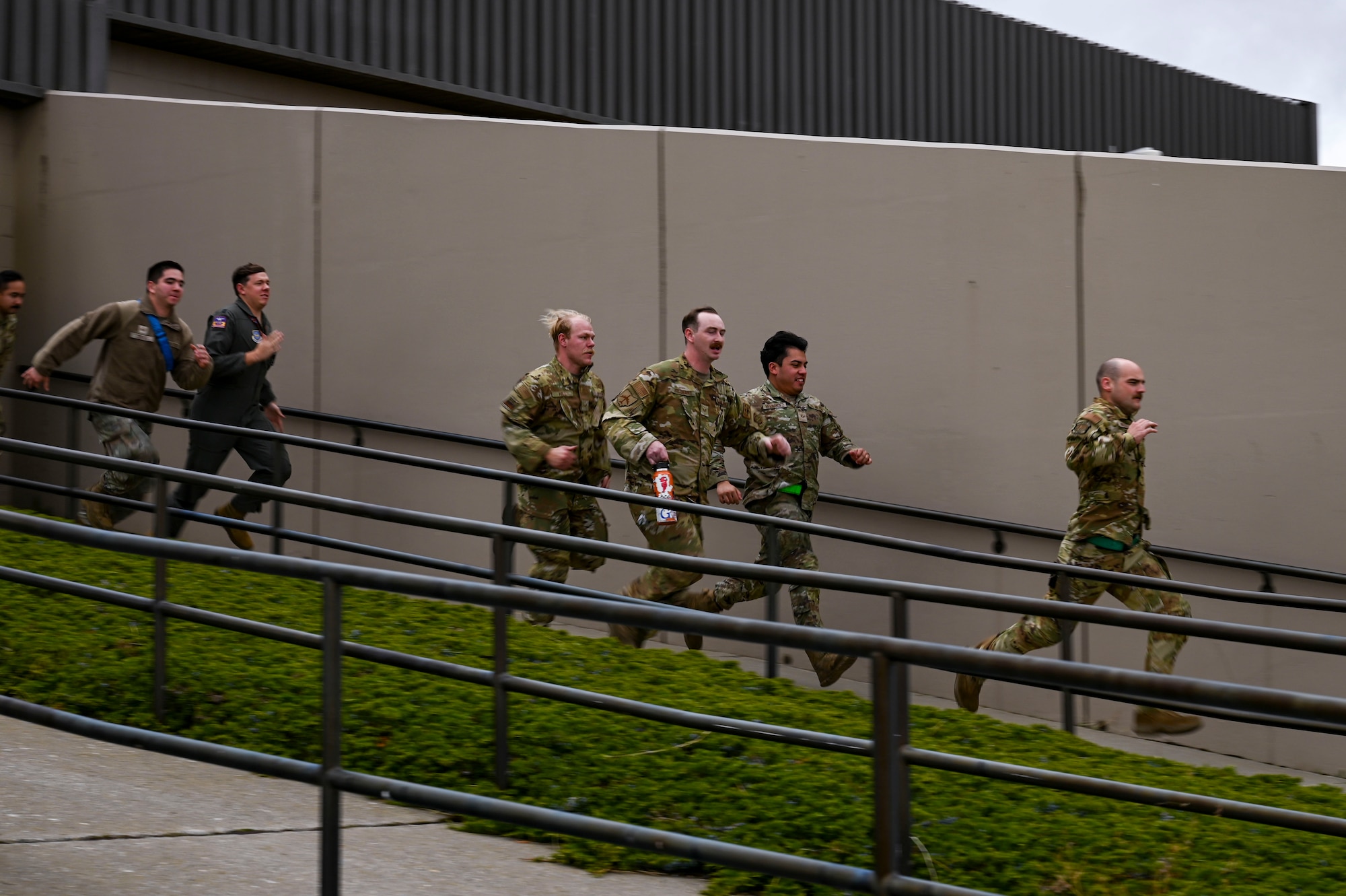 Airmen run out of a building.