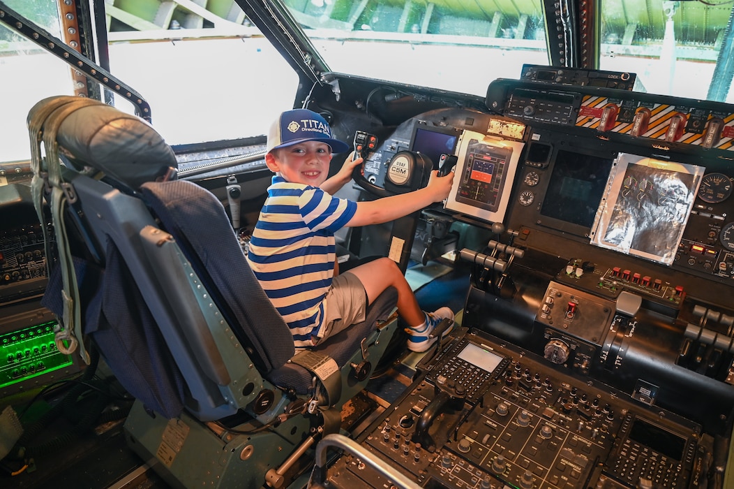 A young airshow goer gets a rare opportunity to sit in the pilot seat of a 433rd Airlift Wing C-5M Super Galaxy during the Wings Over Houston Airshow at Ellington Airport, Houston, Texas Oct. 26, 2024.