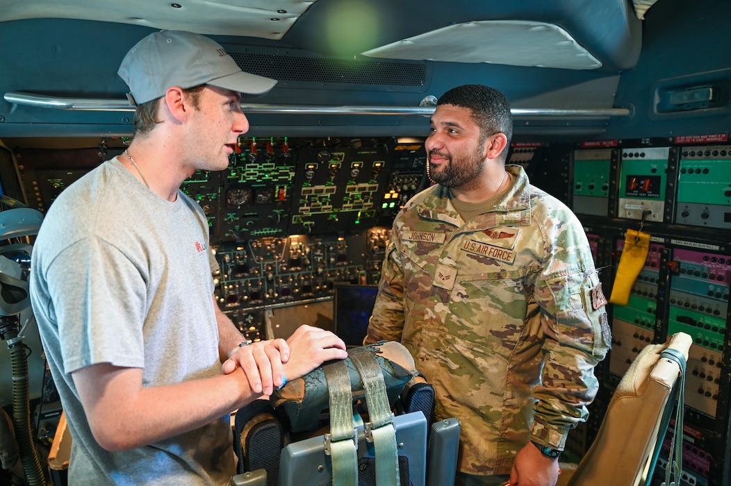 Senior Airman Damien Johnson, 68th Airlift Squadron flight engineer, speaks with an airshow goer interested in learning about being a Reserve Citizen Airman during the Wings Over Houston Airshow at Ellington Airport, Houston, Texas Oct. 26, 2024.