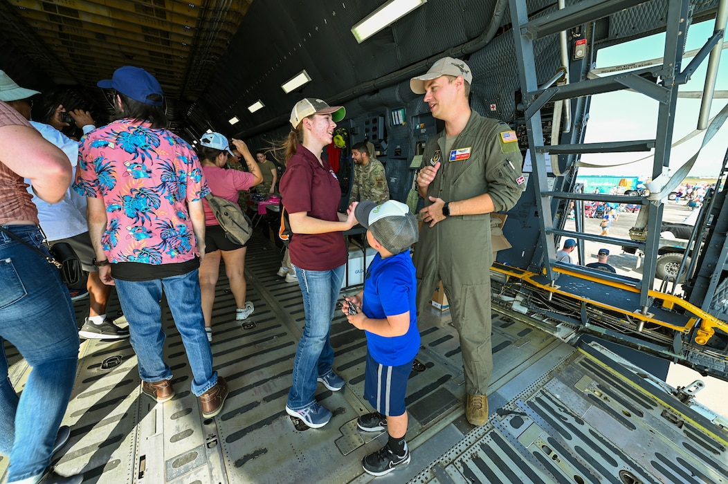 Capt. Britt Talbott, a 68th Airlift Squadron C-5 pilot, speaks with Samantha Smitherman, a marine engineering technology student at Texas A&M University at Galveston, during the Wings Over Houston Airshow at Ellington Airport, Houston, Texas Oct. 26, 2024.