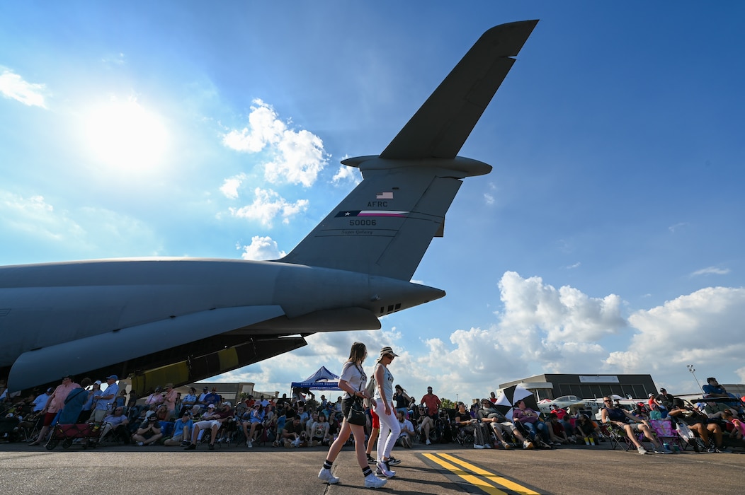 Guests at the Wings Over Houston Airshow gather in the shade provided by the massive wings and tail of 433rd Airlift Wing C-5M Super Galaxy at Ellington Airport, Houston, Texas Oct. 26, 2024.