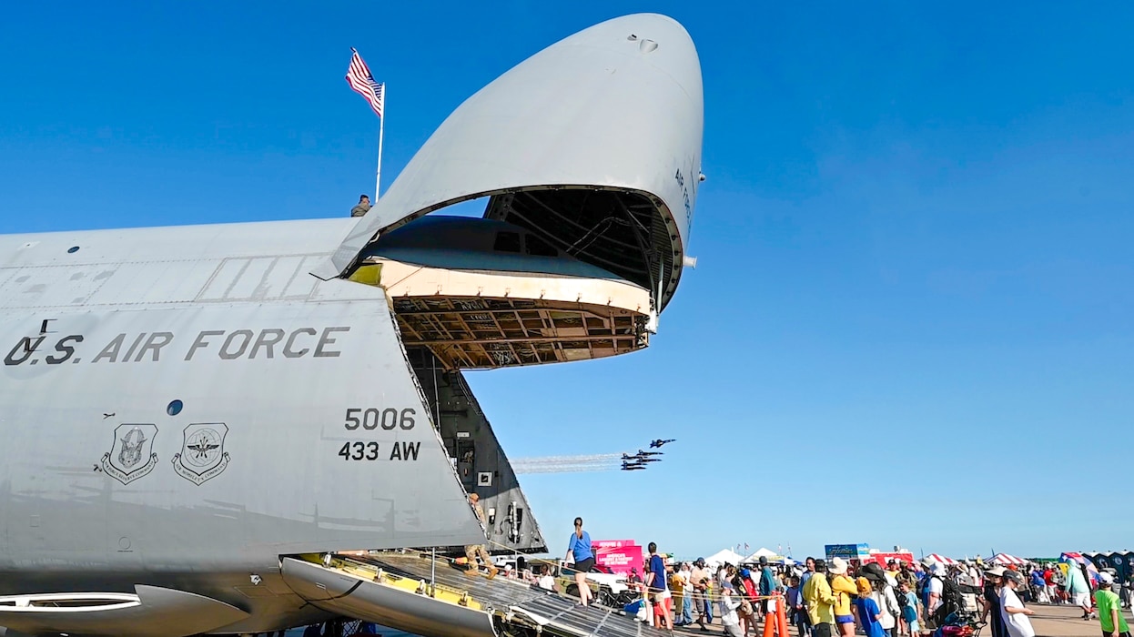 Guests at the Wings Over Houston Airshow view a performance by the U.S. Navy Flight Demonstration Squadron, better known as the “Blue Angels”, from the front ramp of a 433rd Airlift Wing C-5M Super Galaxy at Ellington Airport, Houston, Texas Oct. 26, 2024.