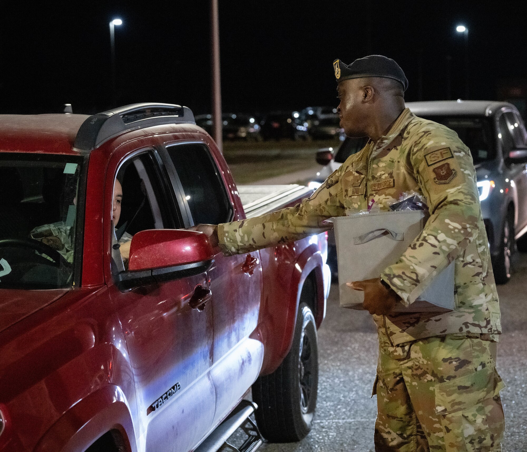 Staff Sgt. Brandon Hall, assigned to 5th Bomb Wing Security Forces Squadron, assists the 5th Bomb Wing Prevention Office by handing out information on domestic violence awareness to members at Minot Air Force Base, North Dakota, Oct. 29, 2024. Domestic Violence Awareness Month started as the national Day of Unity on Oct. 17 in 1981 before becoming Domestic Violence Awareness Month in 1989. (U.S. Air Force photo by Airman 1st Class Wesley Davies)