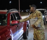 Staff Sgt. Brandon Hall, assigned to 5th Bomb Wing Security Forces Squadron, assists the 5th Bomb Wing Prevention Office by handing out information on domestic violence awareness to members at Minot Air Force Base, North Dakota, Oct. 29, 2024. Domestic Violence Awareness Month started as the national Day of Unity on Oct. 17 in 1981 before becoming Domestic Violence Awareness Month in 1989. (U.S. Air Force photo by Airman 1st Class Wesley Davies)