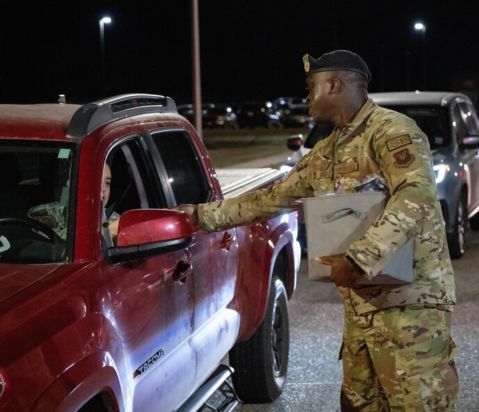 Staff Sgt. Brandon Hall, assigned to 5th Bomb Wing Security Forces Squadron, assists the 5th Bomb Wing Prevention Office by handing out information on domestic violence awareness to members at Minot Air Force Base, North Dakota, Oct. 29, 2024. Domestic Violence Awareness Month started as the national Day of Unity on Oct. 17 in 1981 before becoming Domestic Violence Awareness Month in 1989. (U.S. Air Force photo by Airman 1st Class Wesley Davies)