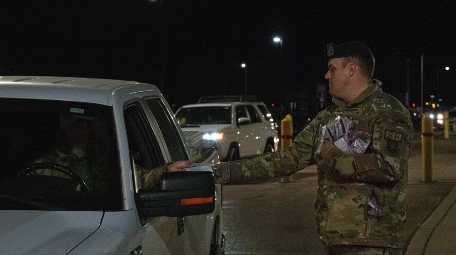 Tech. Sgt. Michael May, assigned to the 5th Bomb Wing Security Forces Squadron, assists the 5th Bomb Wing Prevention Office by giving out pamphlets for domestic violence awareness and resources to members at Minot Air Force Base, North Dakota, Oct. 29, 2024. Since 1989, October has been a time to support domestic violence survivors and advocate for victims. (U.S. Air Force photo by Airman 1st Class Wesley Davies)