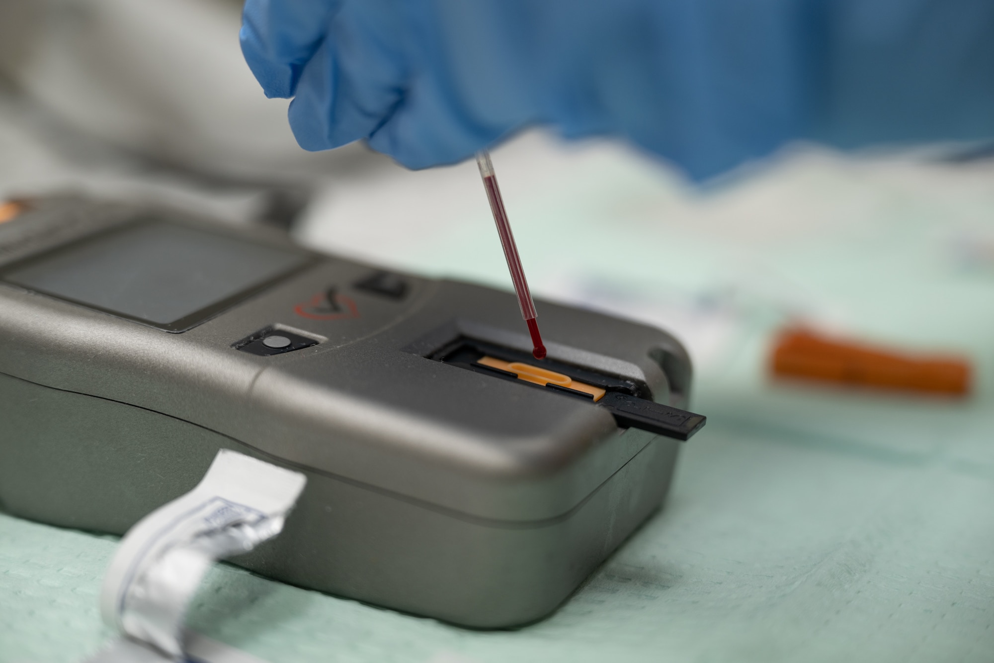 A drop of blood is placed on an analysis machine