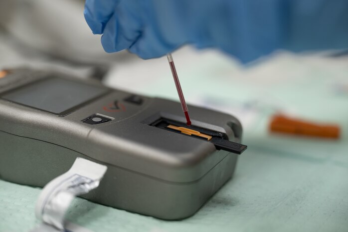A drop of blood is placed on an analysis machine