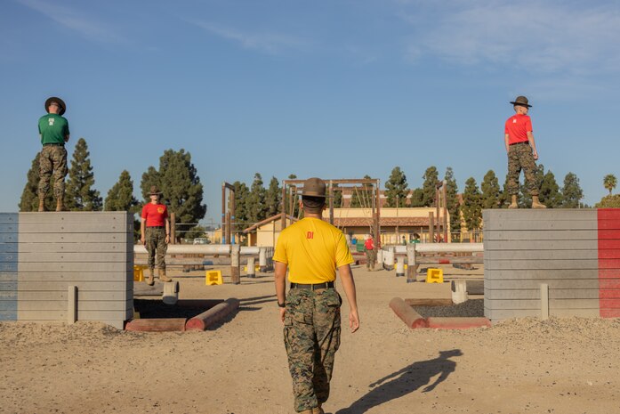U.S. Marine Corps drill instructors with Recruit Training Regiment, wait for contestants during the 2024 Marine Corps Recruit Depot San Diego Boot Camp Challenge at MCRD San Diego, California, Oct. 19, 2024. For the past 23 years, MCRD San Diego has hosted the bootcamp Challenge, a three-mile obstacle course race guided by 60 drill instructors that highlights the physical and mental demands of bootcamp. The event fosters camaraderie and community engagement through interaction with MCRD personnel. (U.S. Marine Corps photo by Lance Cpl. Janell B. Alvarez)