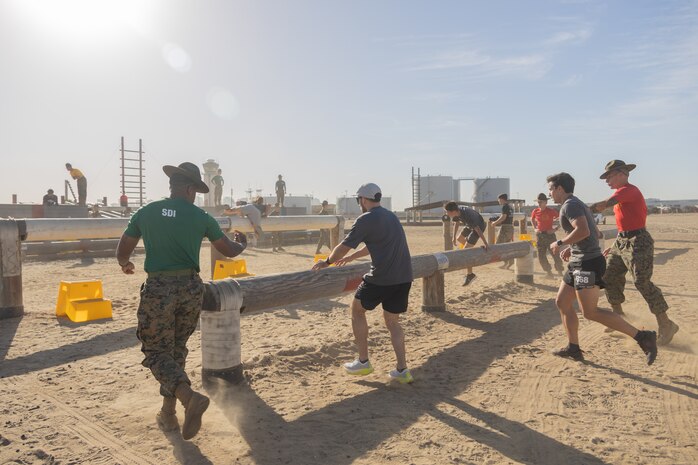 U.S. Marine Corps drill instructors with Recruit Training Regiment, encourage contestants during the 2024 Marine Corps Recruit Depot San Diego Boot Camp Challenge at MCRD San Diego, California, Oct. 19, 2024. For the past 23 years, MCRD San Diego has hosted the bootcamp Challenge, a three-mile obstacle course race guided by 60 drill instructors that highlights the physical and mental demands of bootcamp. The event fosters camaraderie and community engagement through interaction with MCRD personnel. (U.S. Marine Corps photo by Lance Cpl. Janell B. Alvarez)