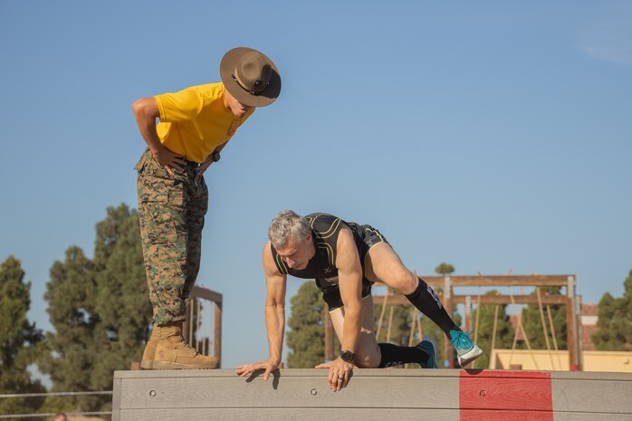 U.S. Marine Corps Sgt. Kevin Gonzalez, a drill instructor with Golf Company, 2nd Recruit Training Battalion, encourages a contestant during the 2024 Marine Corps Recruit Depot San Diego Boot Camp Challenge at MCRD San Diego, California, Oct. 19, 2024. For the past 23 years, MCRD San Diego has hosted the bootcamp Challenge, a three-mile obstacle course race guided by 60 drill instructors that highlights the physical and mental demands of bootcamp. The event fosters camaraderie and community engagement through interaction with MCRD personnel. (U.S. Marine Corps photo by Lance Cpl. Janell B. Alvarez)