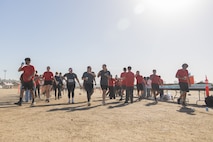 Contestants of the 2024 Marine Corps Recruit Depot San Diego Boot Camp Challenge receive cups of water during the Boot Camp Challenge at MCRD San Diego, California, Oct. 19, 2024. For the past 23 years, MCRD San Diego has hosted the bootcamp Challenge, a three-mile obstacle course race guided by 60 drill instructors that highlights the physical and mental demands of bootcamp. The event fosters camaraderie and community engagement through interaction with MCRD personnel. (U.S. Marine Corps photo by Lance Cpl. Janell B. Alvarez)