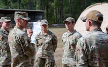 U.S. Air Force Brig. Gen. Stephen Snelson, U.S. Air Force Expeditionary Center commander, and Chief Master Sgt. Dennis Fuselier, USAFEC command chief, speak with Airmen during a visit to Joint Base Charleston, South Carolina, Oct. 29, 2024. During their visit, Snelson and Fuselier gained insight into JB Charleston’s vital contributions to global mobility, rapid deployment, and joint operations.(U.S. Air Force photo by Senior Airman Christian Silvera)