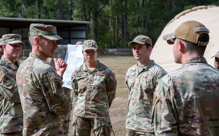 U.S. Air Force Brig. Gen. Stephen Snelson, U.S. Air Force Expeditionary Center commander, and Chief Master Sgt. Dennis Fuselier, USAFEC command chief, speak with Airmen during a visit to Joint Base Charleston, South Carolina, Oct. 29, 2024. During their visit, Snelson and Fuselier gained insight into JB Charleston’s vital contributions to global mobility, rapid deployment, and joint operations.(U.S. Air Force photo by Senior Airman Christian Silvera)