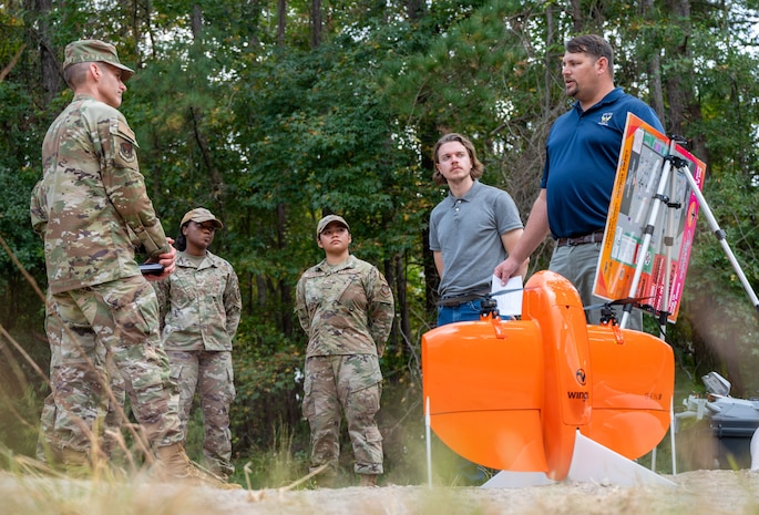 U.S. Air Force Brig. Gen. Stephen Snelson, U.S. Air Force Expeditionary Center commander, learns about the Small Unmanned Aerial System program development and capabilities during a visit to Joint Base Charleston, South Carolina, Oct. 29, 2024. The USAFEC command team engaged with Airmen and Sailors across the installation, observing firsthand their innovative approaches to enhancing mission success and operational readiness. (U.S. Air Force photo by Senior Airman Christian Silvera)