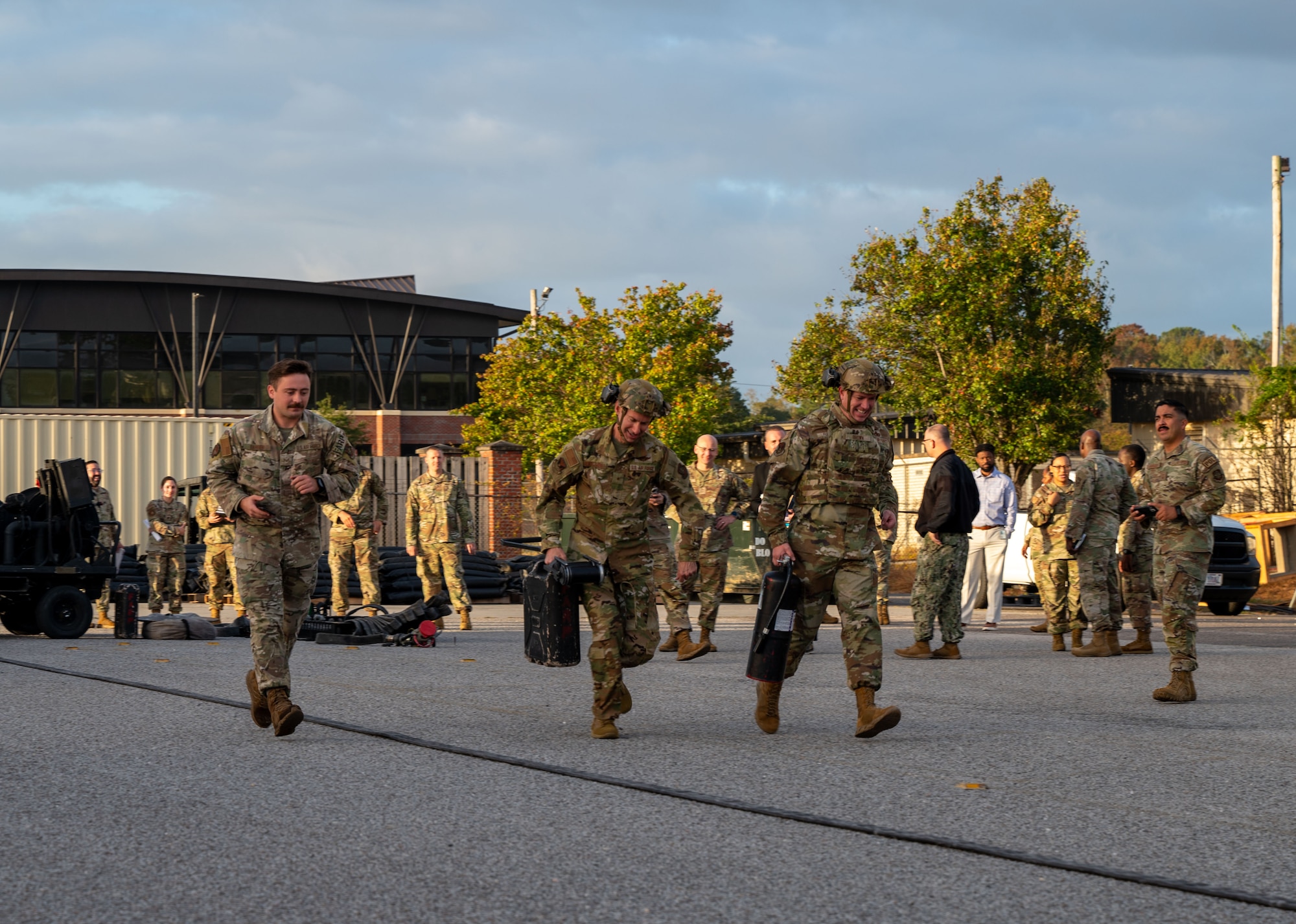 U.S. Air Force Brig. Gen. Stephen Snelson, U.S. Air Force Expeditionary Center commander, and Chief Master Sgt. Dennis Fuselier, USAFEC command chief,  participate in a hands-on forward area refueling point demonstration during a visit to Joint Base Charleston, South Carolina, Oct. 30, 2024. During their visit, Snelson and Fuselier gained insight into JB Charleston’s vital contributions to global mobility, rapid deployment, and joint operations. (U.S. Air Force photo by Senior Airman Christian Silvera)