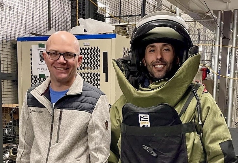 Two people smile for a photo.