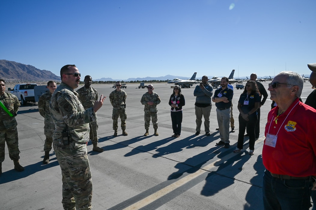 Chief Master Sgt. Paul Cocanour, 926th Aircraft Maintenance Squadron superintendent, briefs Greater San Antonio area civic leaders about the F-16 Fighting Falcon mission as aggressors during training operations on the flightline at Nellis Air Force Base, Nevada, Oct. 23, 2024.