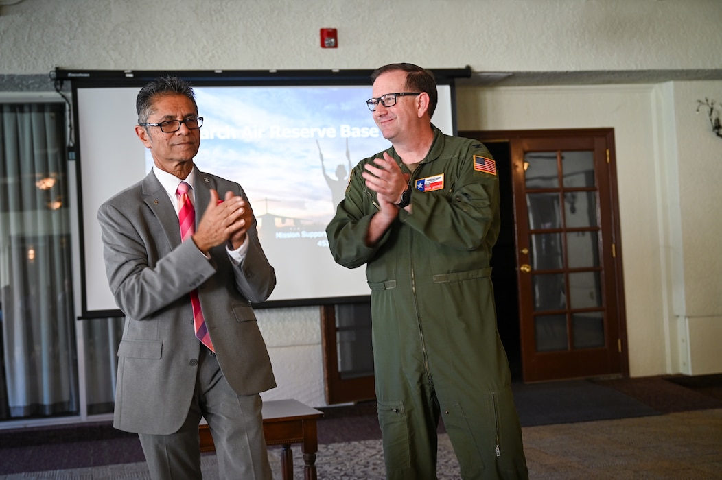 Col. Douglas C. Jeffrey, IV, 433rd Airlift Wing commander, gives a round of applause to Jamil Dada, Air Force Reserve Command civic leader, after briefing 16 Greater San Antonio area civic leaders about the importance of being an active military civic leader for the community at March Air Reserve Base, Calif., Oct. 24, 2024.