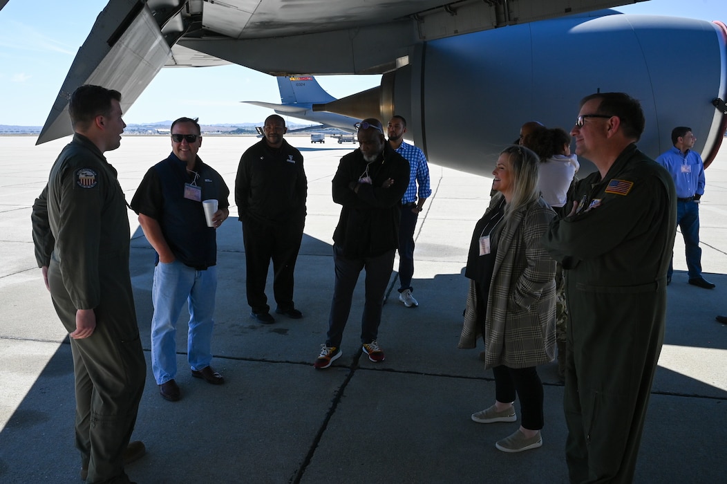 Senior Airman Cooper Strople, 336th Air Refueling Squadron boom operator, briefs Col. Douglas C. Jeffrey, IV, 433rd Airlift Wing commander, and Joint Base San Antonio-Lackland civic leaders about the KC-135 Stratotanker refueling mission at March Air Reserve Base, California, Oct. 24, 2024.