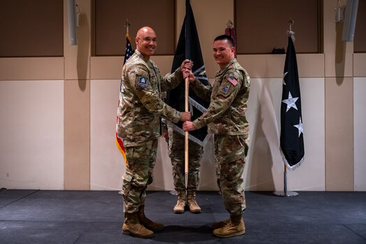 U.S. Space Force Lt. Gen. David N. Miller, Jr., Space Operations Command commander passes the Mission Delta 4 guidon to Col. Ernest “Bobby” Schmitt, MD 4 commander, during the MD 4 redesignation ceremony, Oct. 30, 2024. Mission Deltas oversee all aspects of mission area functions – people, training, equipment and combat sustainment.