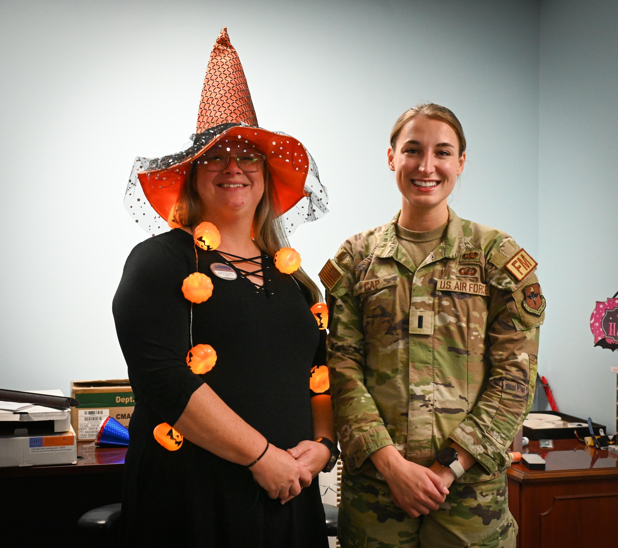 Natanya Watkinson, 47th Force Support Squadron, work life consultant, left, and 1st Lt. Sarah Cap, Financial Operations Flight, flight commander, right pose to take a photo, Laughlin AFB, Oct. 31, 2024. Watkinson and Cap helped resolve TSP errors impacting student pilots. ( U.S. Airforce photo by Airman 1st Class Harrison Sullivan)