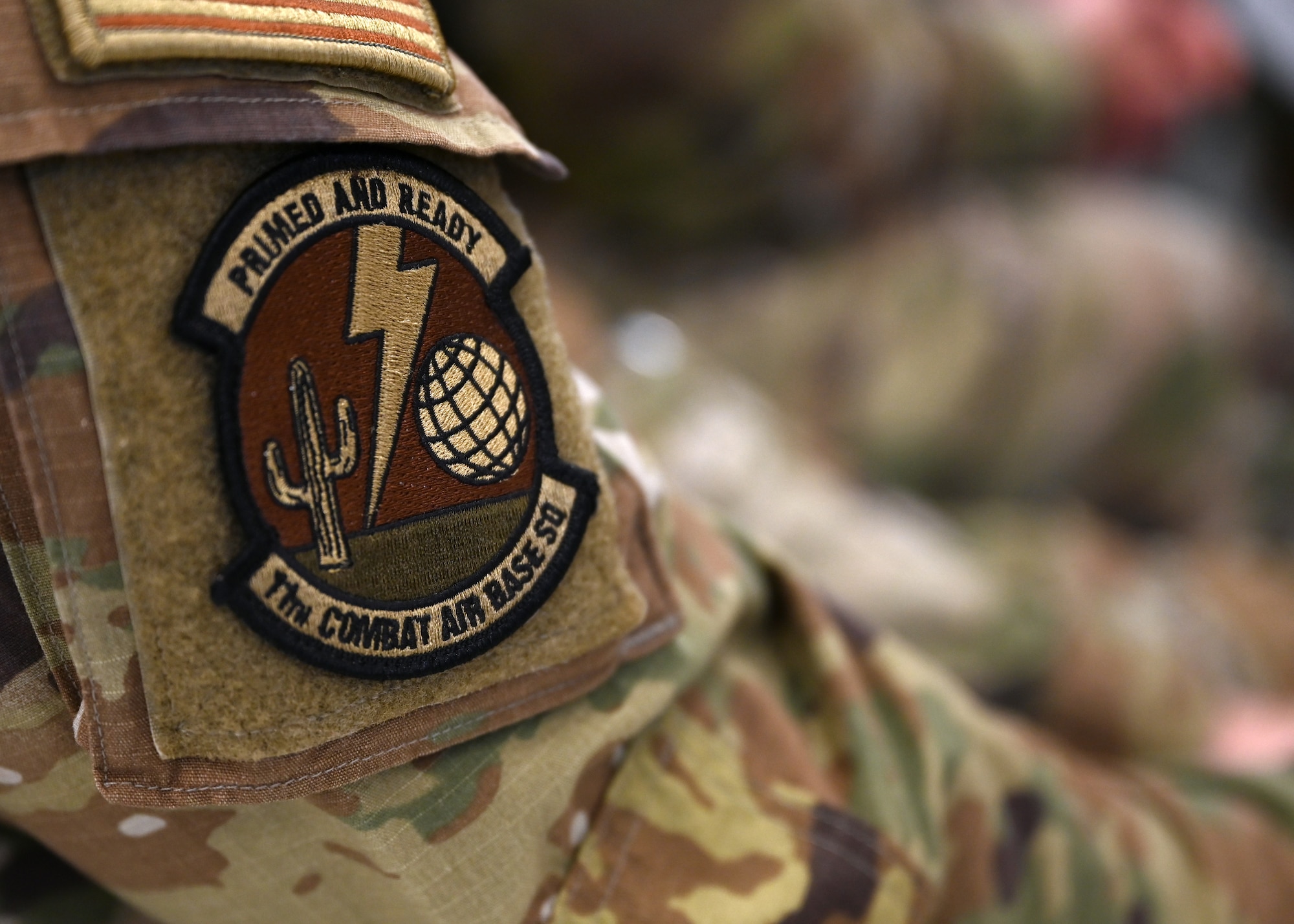 The 11th Combat Air Base Squadron patch is displayed at the activation and assumption of command for the 11th Combat Air Base Squadron at Davis-Monthan Air Force Base, Arizona, Oct. 31, 2024. Belonging to Air Force Special Operations Command under the 11th Air Task Force, the 11th CABS is an elite squadron designed to execute flexible and uncharted mission directives, worldwide. (U.S. Air Force photo by Staff Sgt. Abbey Rieves)