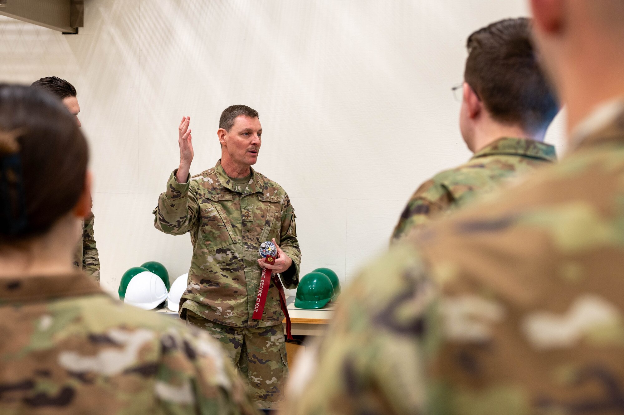 U.S. Air Force Senior Master Sgt. Lance Deihm, 354th Munitions Squadron production flight chief, explains the inner workings of a fuse to Airman Leadership School class 25-1 students at Eielson Air Force Base, Alaska, Oct. 28, 2024.
