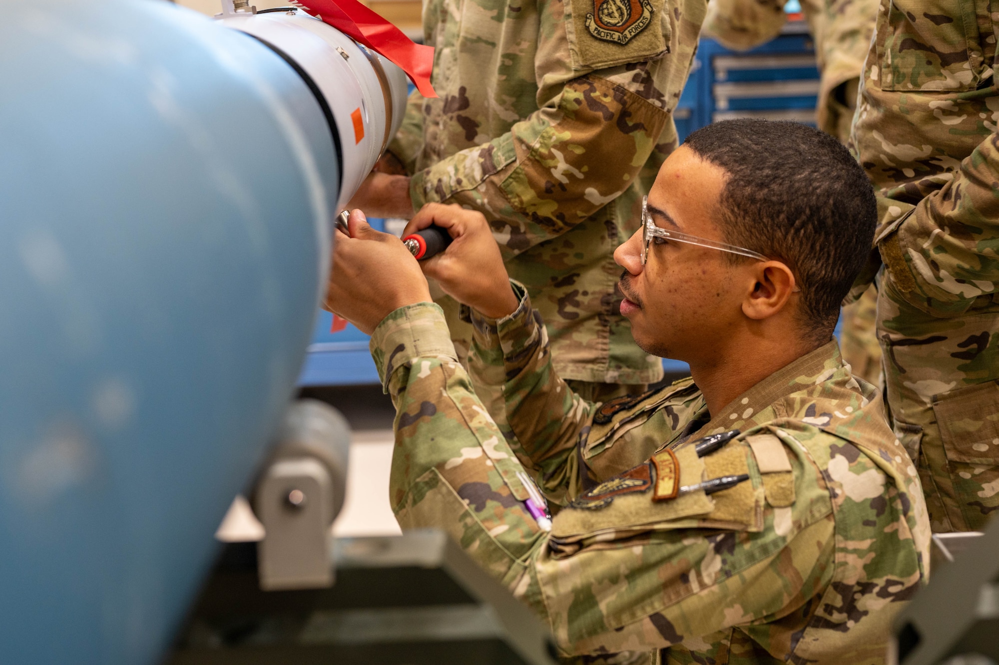 U.S. Air Force Senior Airman Torey Hamilton, Eielson Airman Leadership School class 25-1 student, tightens a screw onto an inert GBU-12 Paveway II at Eielson Air Force Base, Alaska, Oct. 28, 2024.