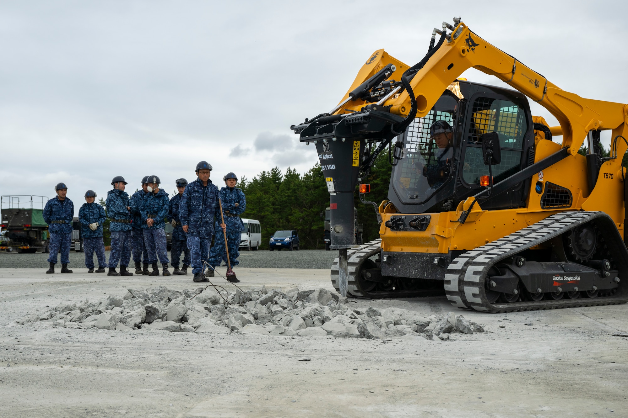 Japan Maritime Self Defense Members drill out a hole