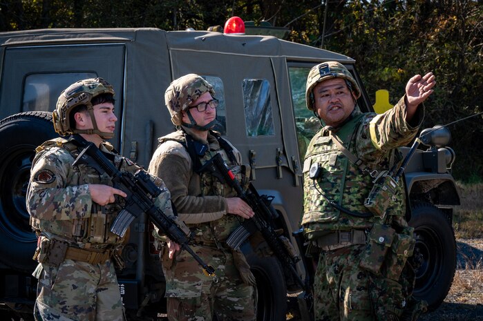 Airmen receive directions from a JGSDF member