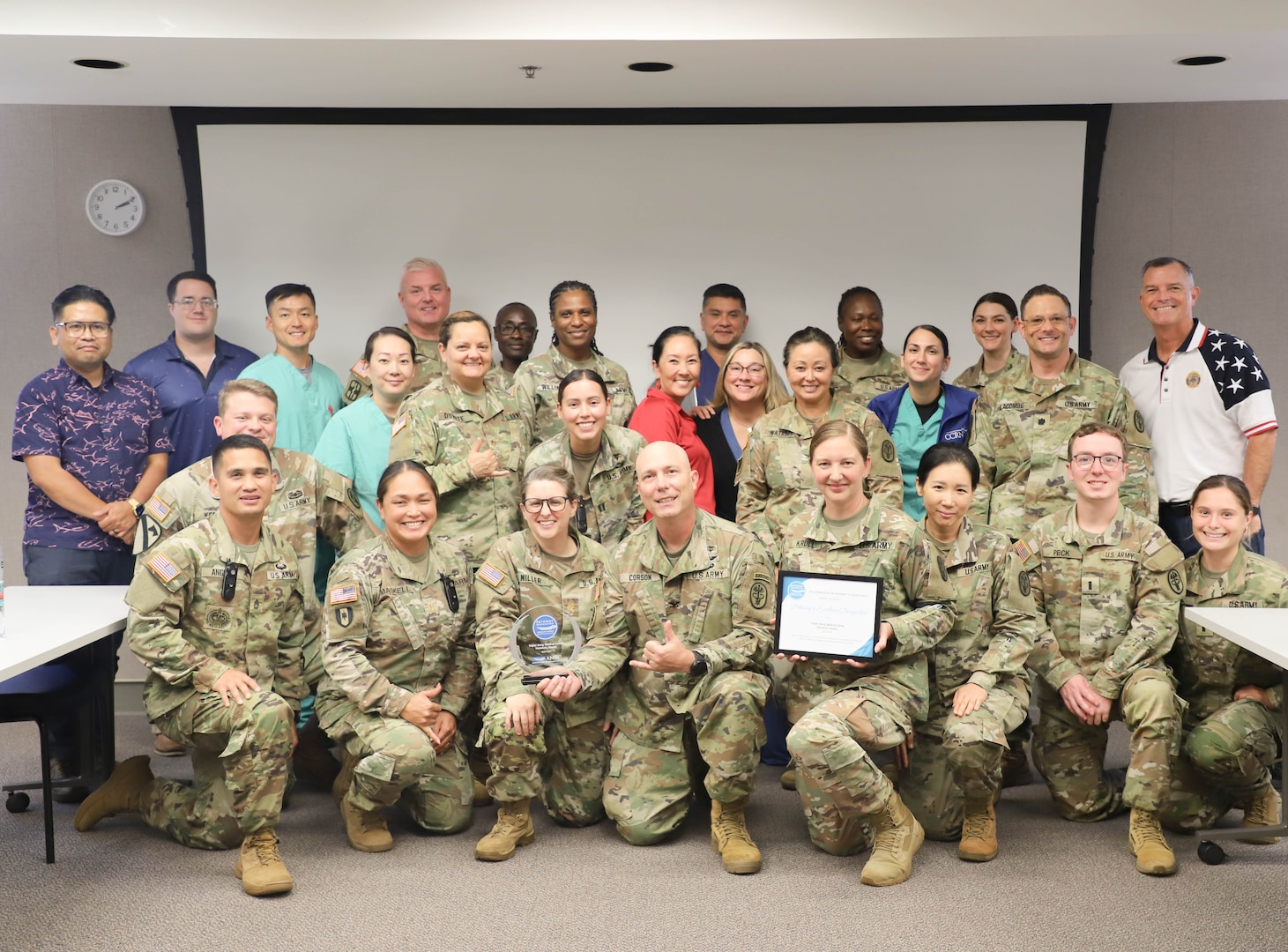 Nurses from Tripler Army Medical Center pose with an award and a certificate commemorating the hospital's designation as a Pathway to Excellence organization on Aug. 27, 2024. (Defense Health Agency photo by Khinna Kaminske)