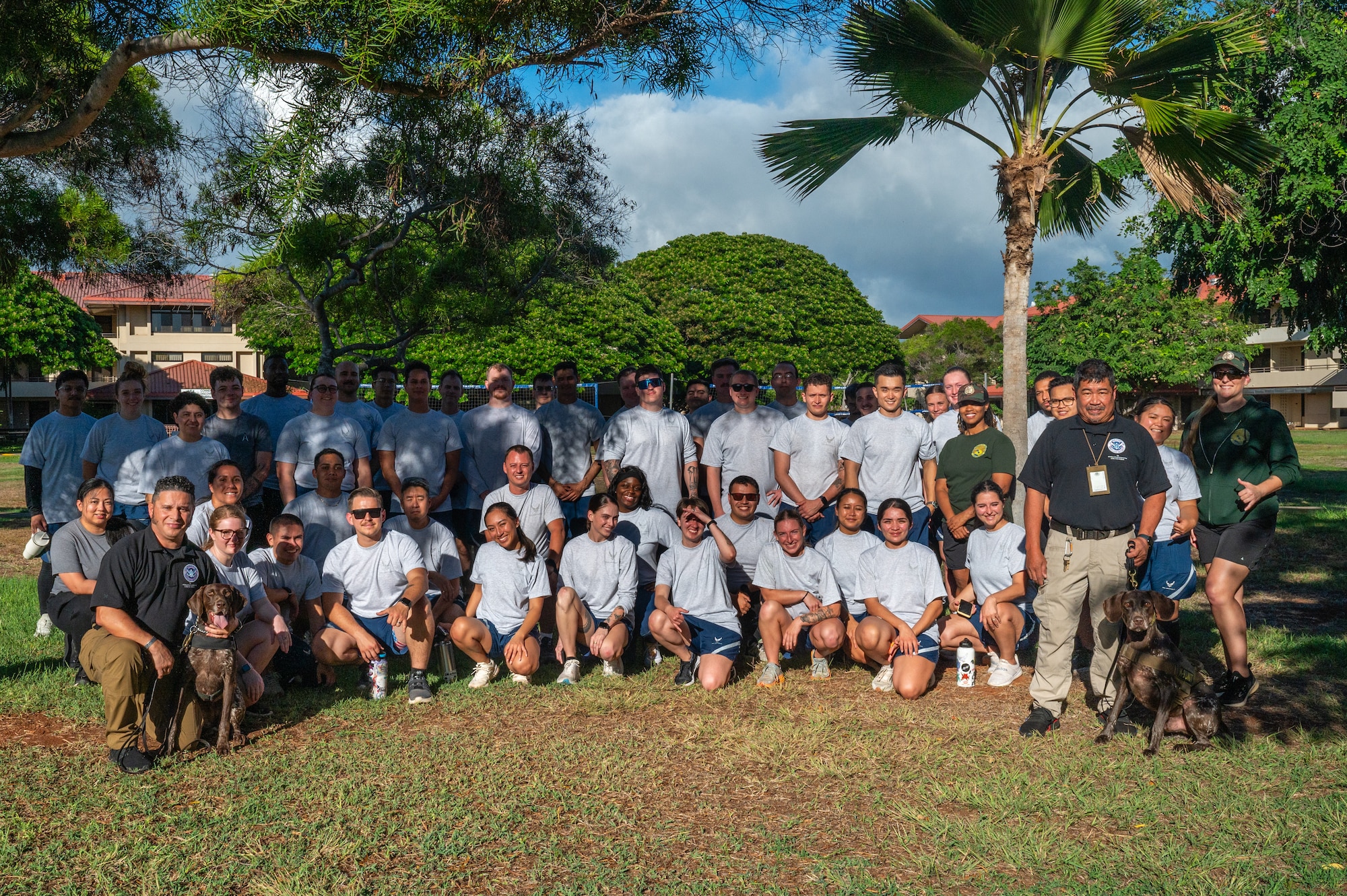 Airman Leadership School students pose for group photo with TSA working dogs and handlers.