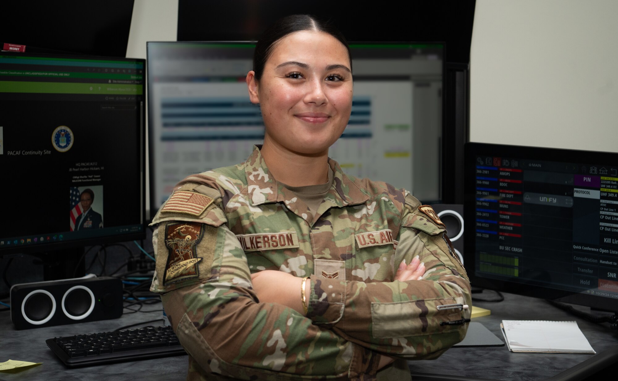 Airman 1st Class Cheyenne Wallowingbull, 36th Command Post junior emergency actions controller, assists Senior Airman Andrew Vance, 36th Command Post senior EAC, in the command and control center at Andersen Air Force Base, Guam, Oct. 29, 2024. Essentially, Command Post upchannels and downchannels information 24/7. Anything from an injuries or damage to property, up to force protection conditions changes, or National Security updates that affect the base. They get almost all information and disseminate it accordingly. (U.S. Air Force photo by Staff Sgt. Pedro Tenorio)