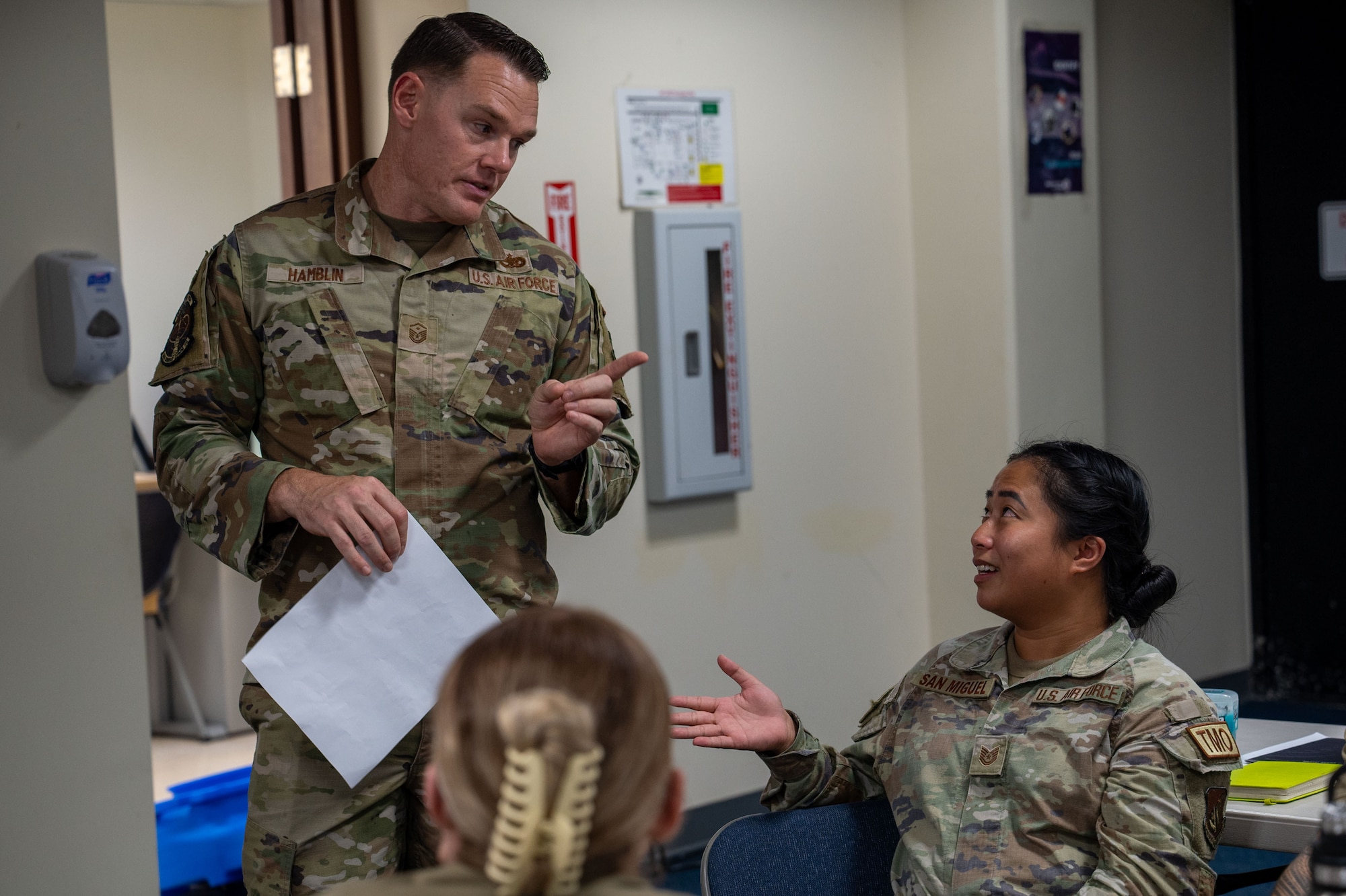 U.S. Air Force Master Sgt. Jeremy Hamblin, 644th Combat Communications Squadron first sergeant, and Tech. Sgt. Joselle San Miguel, 36th Logistics Readiness Squadron inbound cargo noncommissioned officer in charge, discuss what to do during a potential scenario during a First Sergeant Symposium at Andersen Air Force Base, Guam, Oct. 28-31, 2024. The symposium was held to train Technical Sergeants and above on how to be an interim first sergeant when current first sergeants are unavailable. (U.S. Air Force photo by Audree Campbell)