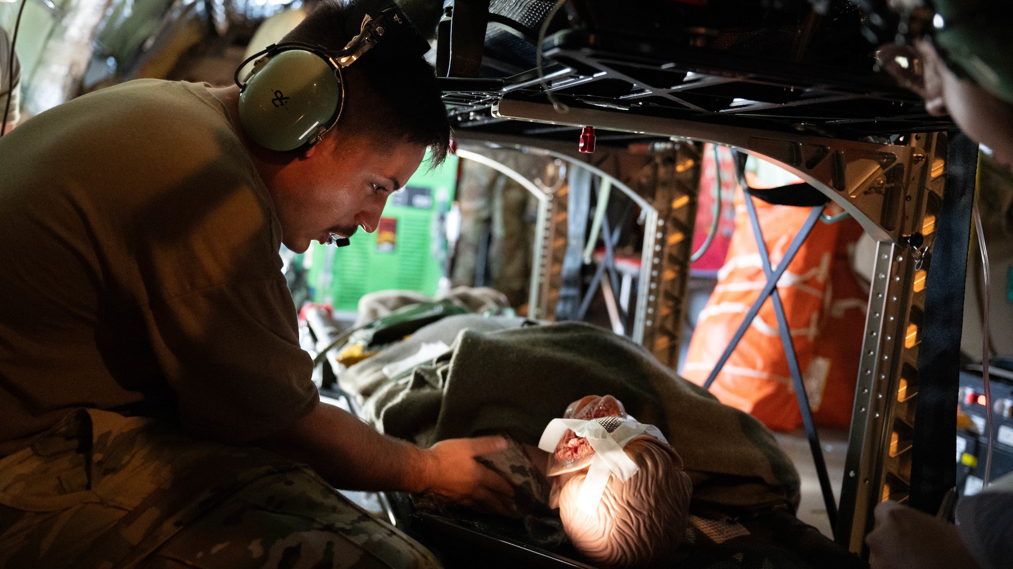 Airman from the 18th AES checks on a simulated patcient