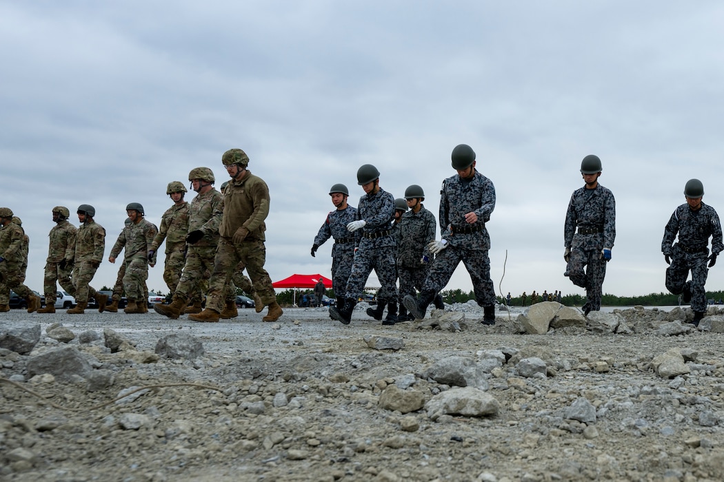 U.S. Airmen assigned to the 35th Civil Engineer Squadron, and Japanese Armed Forces muster for a safety brief prior to a bilateral rapid airfield damage repair exercise as part of Keen Sword 25 at Draughon Range near Misawa Air Base, Japan, Oct. 30, 2024.