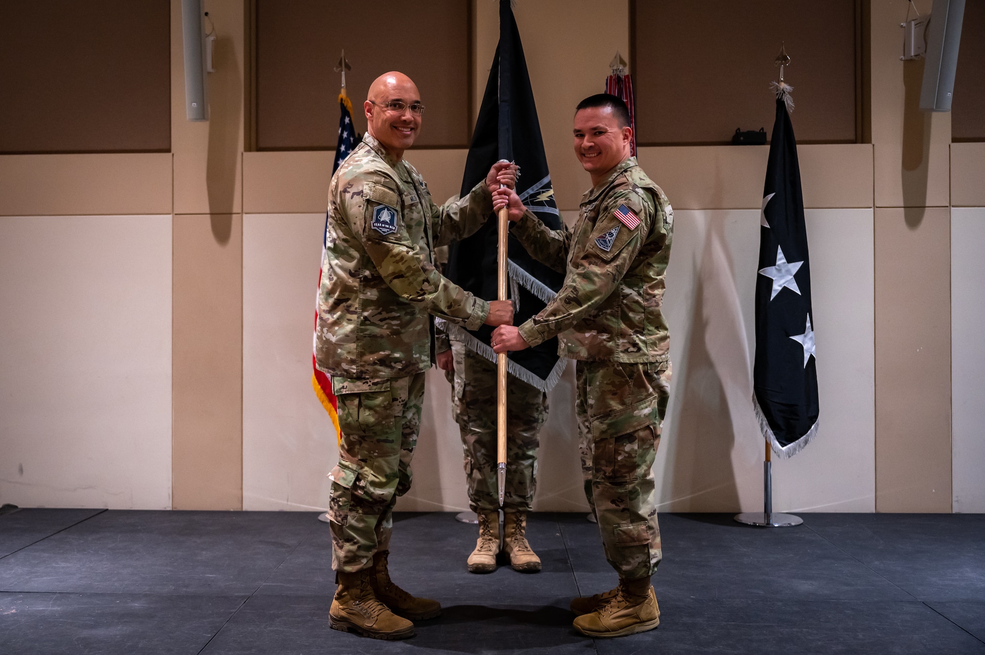 U.S. Space Force Lt. Gen. David N. Miller, Jr., Space Operations Command commander passes the Mission Delta 4 guidon to Col. Ernest “Bobby” Schmitt, MD 4 commander, during the MD 4 redesignation ceremony, Oct. 30, 2024. Mission Deltas oversee all aspects of mission area functions – people, training, equipment and combat sustainment.