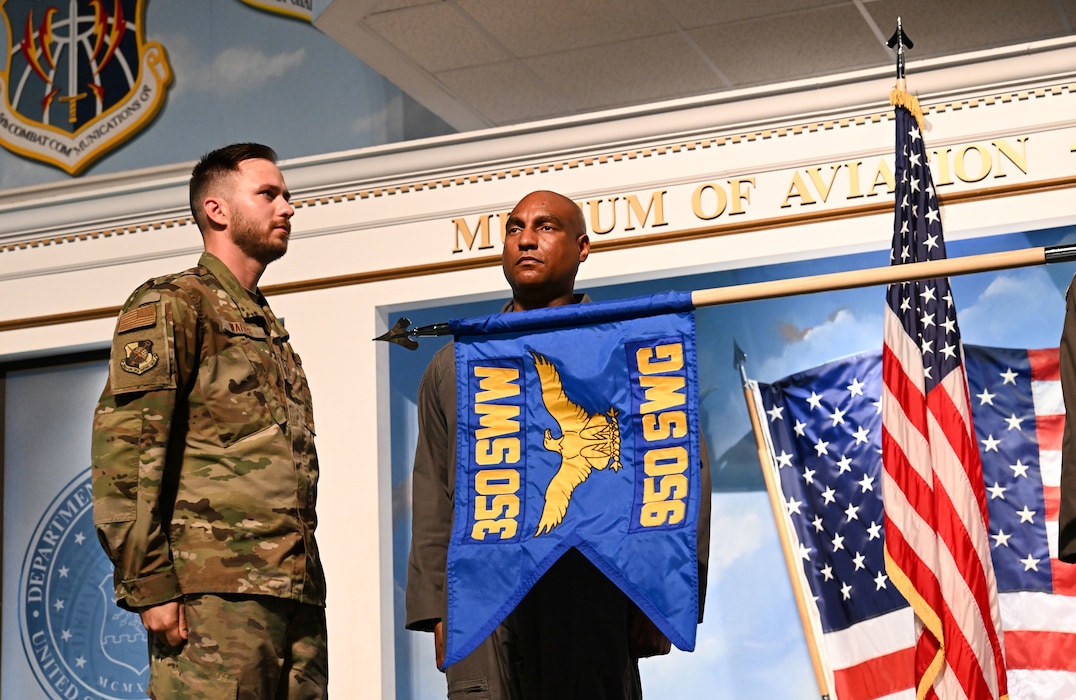 Photo shows two men with blue flag