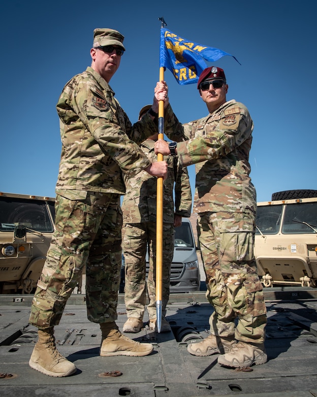 Lt. Col. Aaron Zamora, right, incoming commander of the Kentucky Air National Guard’s 123rd Contingency Response Group, accepts the group guidon from Col. Bruce Bancroft, 123rd Airlift Wing commander, during a change-of-command ceremony at Amedee Army Airfield, Calif., Aug. 26, 2024. The ceremony took place at the end of a week-long exercise that tested the 123rd CRG’s capability to conduct a Joint Task Force-Port Opening, an operation designed to safely and effectively distribute cargo and supplies to austere areas affected by catastrophic events or conflict. (U.S. Air National Guard photo by Master Sgt. Joshua Horton)