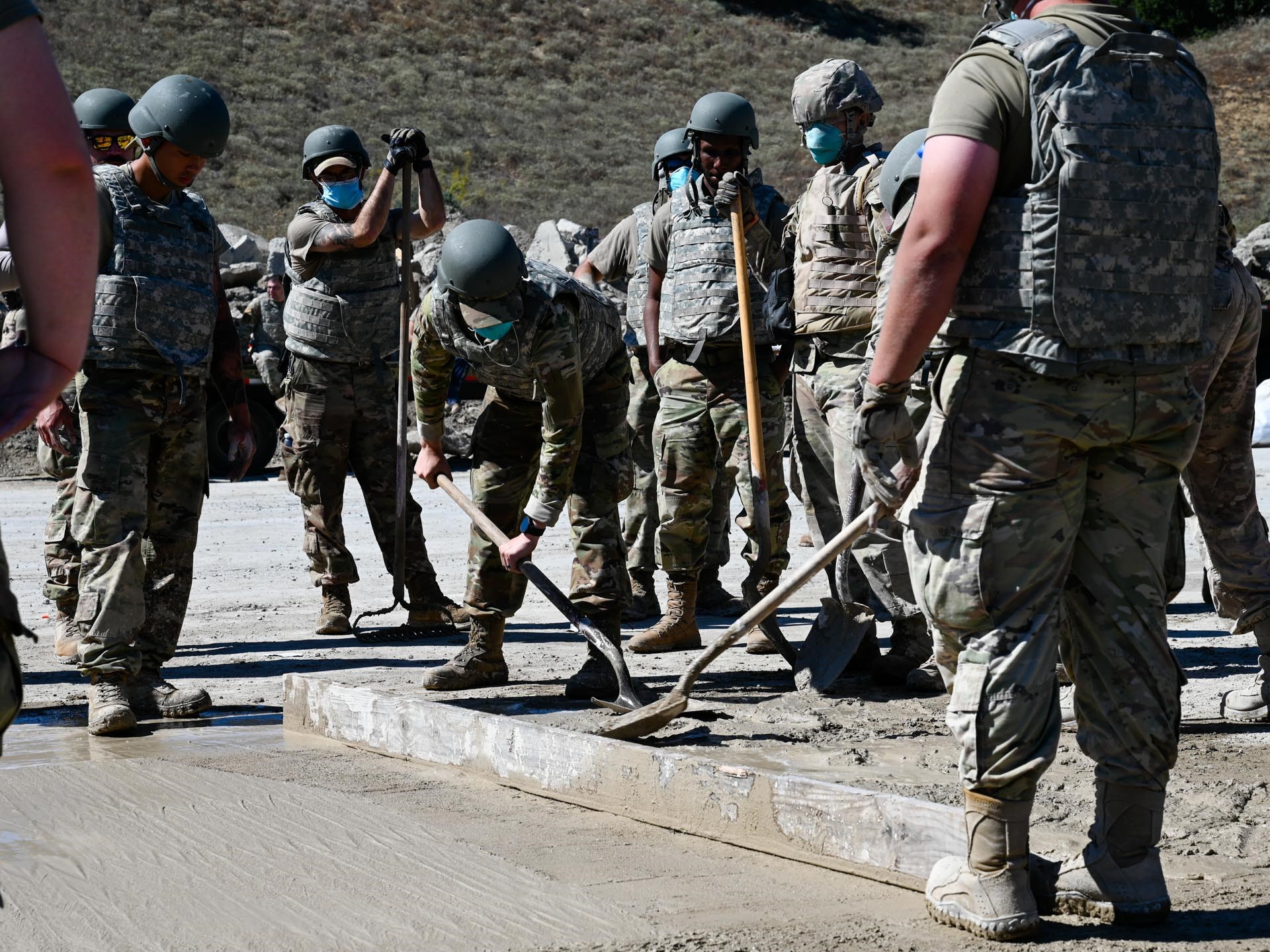 A group of Civil Engineer Squadron members smooth concrete during a Rapid Airfield Runway Repair training at Vandenberg Space Force Base, Calif., Sept. 26, 2024. The training aimed to improve their skills and experience under different strains and pressures within a simulated deployed environment. Vandenberg’s 30th CES, 21st CES from Peterson Space Force Base, and 61st Civil Engineer and Logistics Squadron members from Los Angeles Air Force Base trained on core civil engineer competencies in a setting mimicking a deployed environment. (U.S. Space Force photo by Senior Airman Joshua LeRoi)