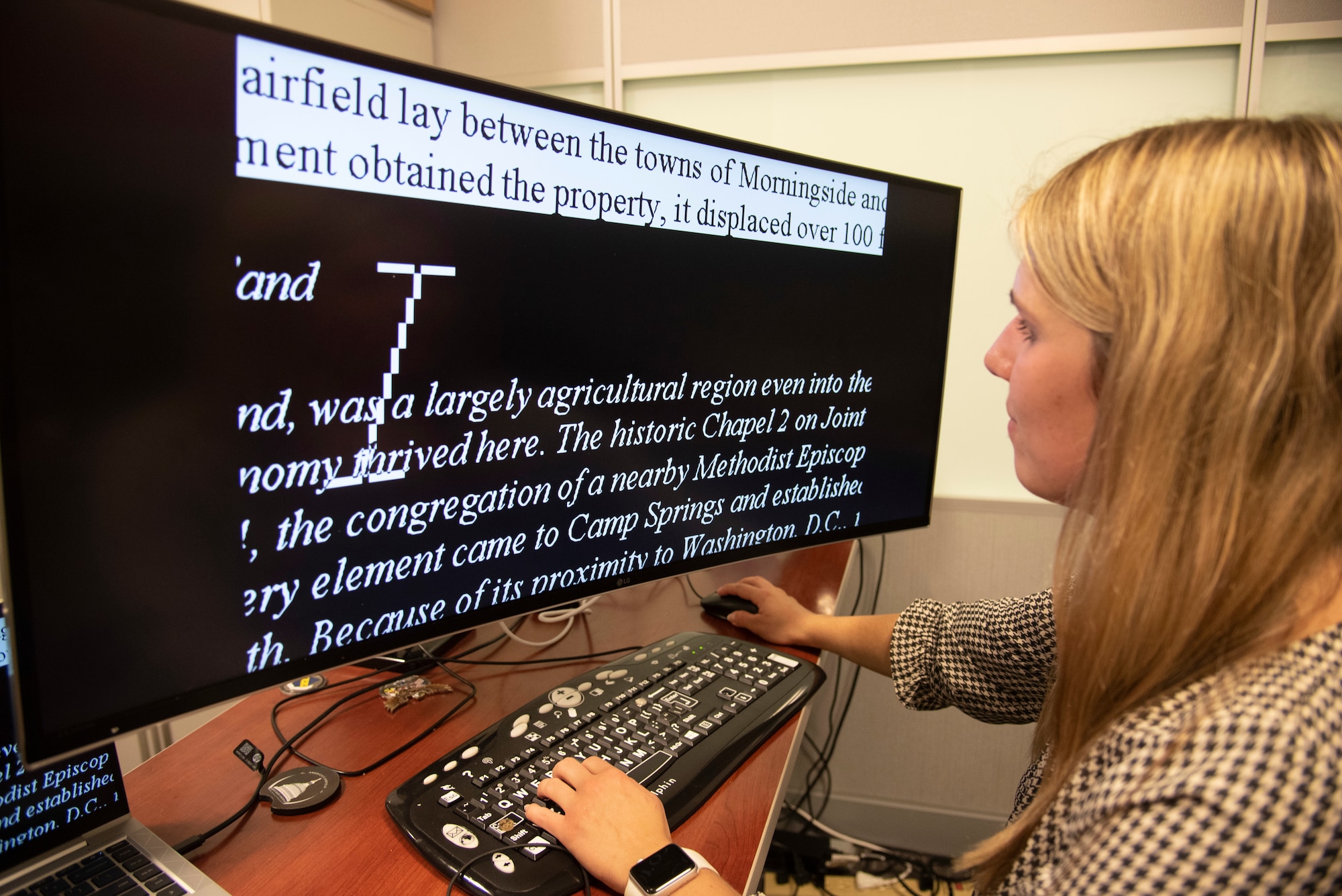 Meaghan M. Kacmarcik, 316th Wing deputy historian, who was diagnosed with a visual impairment disease when she was 10, uses ZoomText Fusion to magnify text on her computer at Joint Base Andrews, Md., Oct. 24, 2024. Her passion for history has helped her overcome obstacles she has encountered because of her vision impairment. (U.S. Air Force photo by Patrick Griffith)