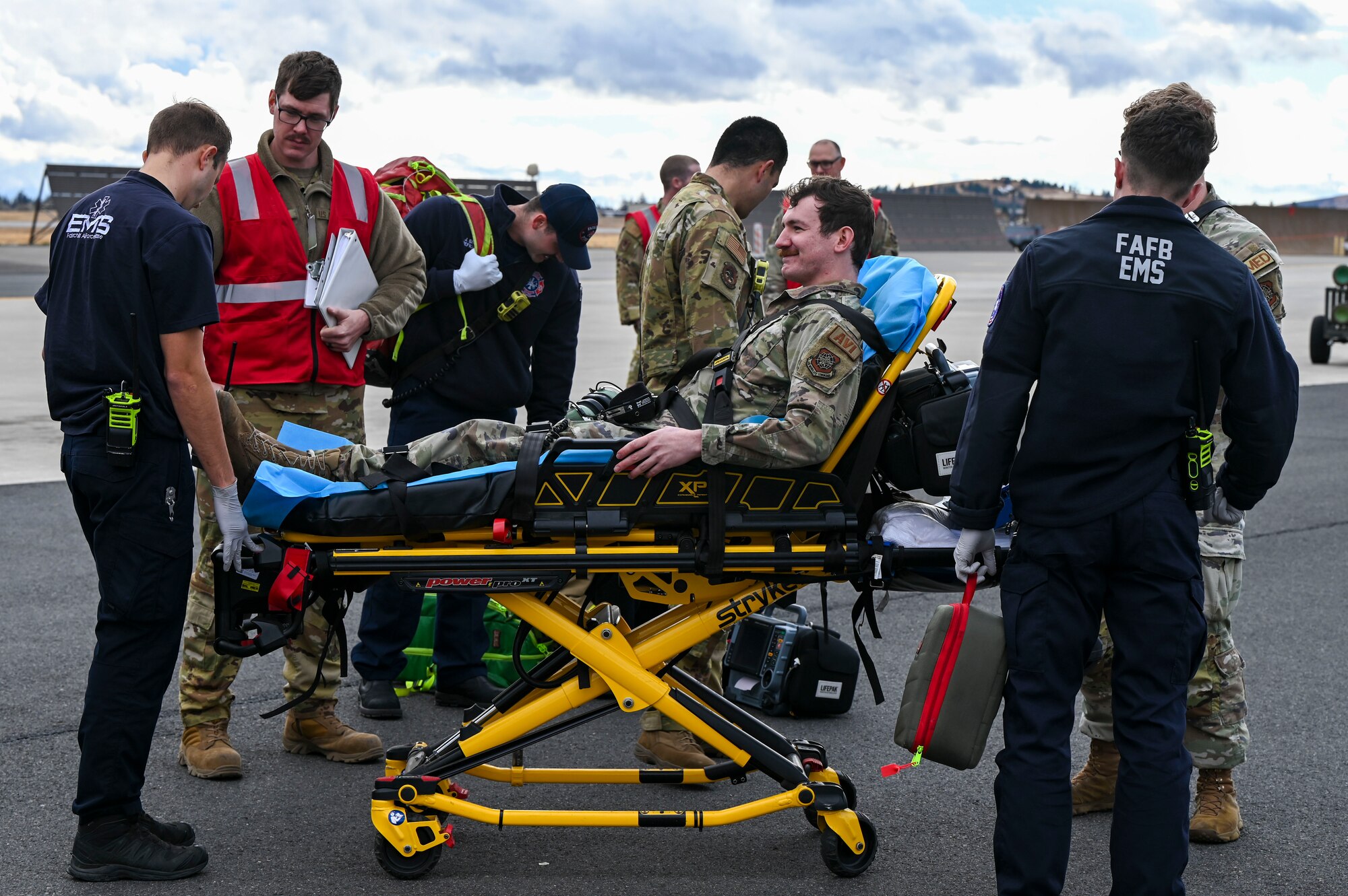 An Airman is laying in a stretcher.