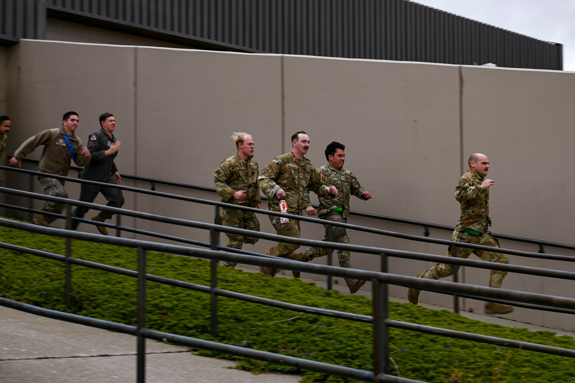 Airmen run out of a building.